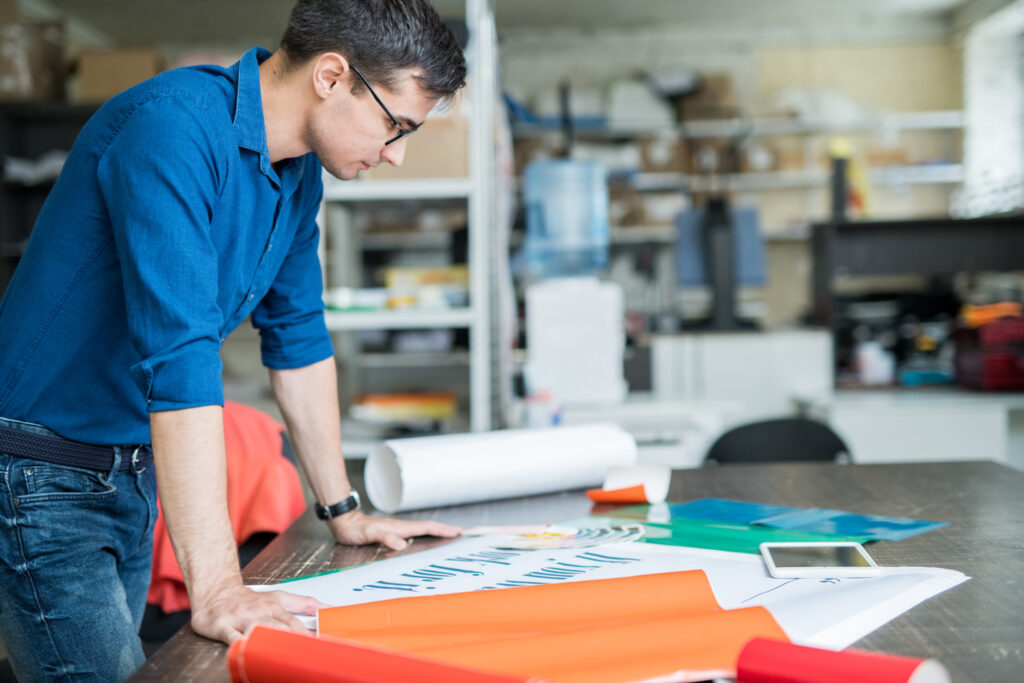 Man reviewing printed proofs